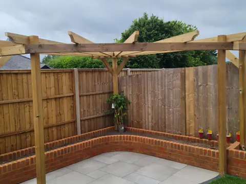 Timber pergola over a curved paved seating area